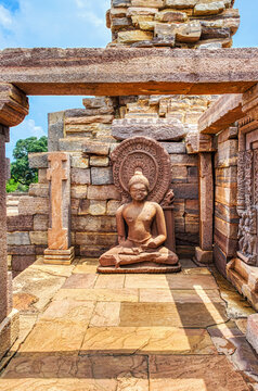 Ancient Seated Buddha Sculpture with Halo at Sanchi Archaeological Site, India