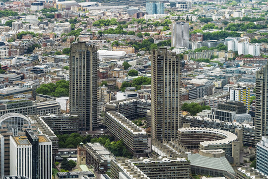 View of the Barbican Estate with its iconic brutalist concrete towers, residential blocks, and lush green courtyards in the heart of London, England, United Kingdom.