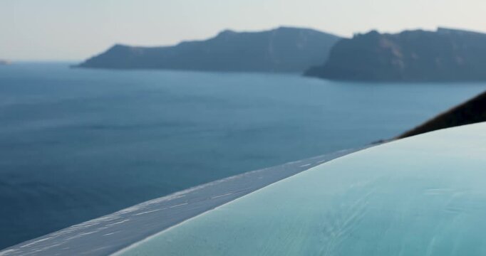 Infinity pool overlooking the Santorini caldera in Greece with gentle water movement and panoramic views of the Aegean Sea, creating a luxury travel scene in the Mediterranean during summer.