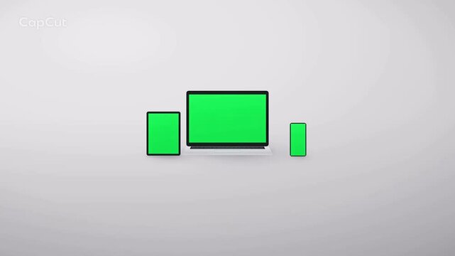 Laptop tablet and smartphone mockup with green screens on grey studio backdrop and slow zoom