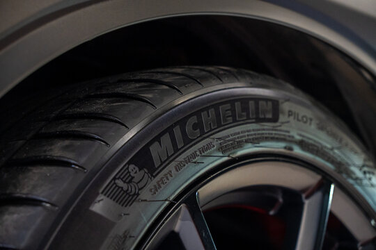 Close-up of premium French Michelin Pilot Sport 4 ZP car tire rubber sidewall with brand logo text lettering black alloy wheel rim, high performance automotive equipment of famous France manufacturer.
