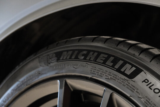 Close-up of premium French Michelin Pilot Sport 4 ZP car tire rubber sidewall with brand logo text lettering black alloy wheel rim, high performance automotive equipment of famous France manufacturer.