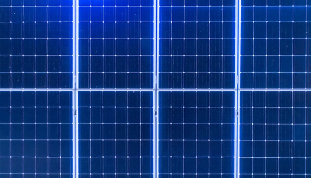 Solar panels background featuring blue photovoltaic cells arranged in a grid pattern for renewable energy and sustainable power generation concepts