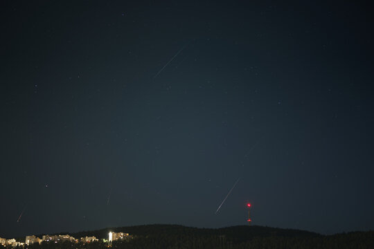Meteor Trails and Shooting Stars Over Dark Nordic Forest Hill at Night
