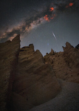 View of the Lame Rosse rock pinnacles under a starry night sky with the Milky Way visible above the eroded landscape in Fiastra, Marche, Italy.