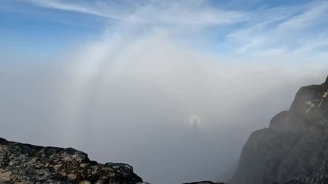 Rare Fogbow White Rainbow Arcing Over Rocky Mountain Peak in Sea of Fog Senja Northern Norway