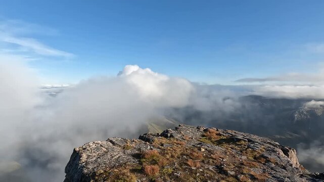Rocky Mountain Summit with Sea of Clouds and Clear Blue Sky on Keipen Senja Northern Norway