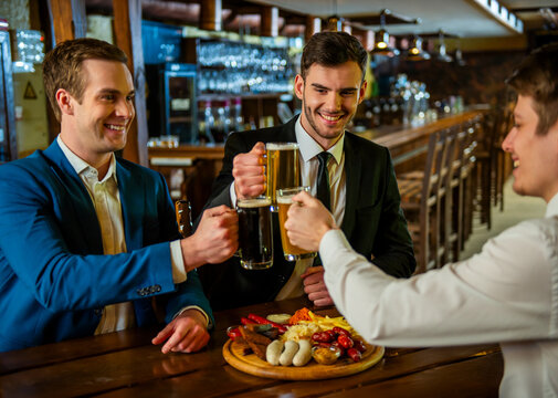 Businessmen Toasting Beer Together.