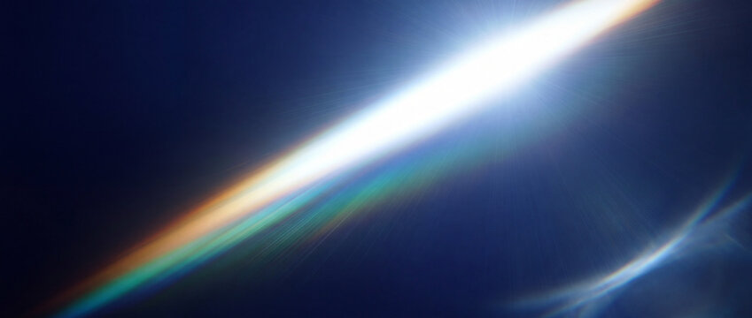 Lens flare with rainbow colors on dark blue background, abstract light effect for creative design and digital art backgrounds for commercial technology, business, marketing, web