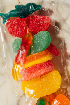 close up of plastic wrapped gummy candy on skewer, candy kabob