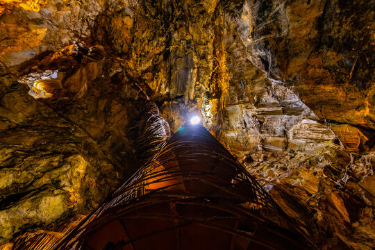 Moaning Caverns formations glow illuminated in darkness
