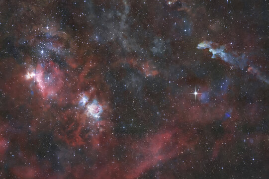 View of the vibrant Orion Nebula and the Running Man Nebula featuring glowing clouds of interstellar gas, dust, and bright stars in deep space, Italy.