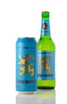 August 10, 2026, Tbilisi, Georgia A studio product shot of a blue aluminum can and a green glass bottle of L&ouml;wenbr&auml;u M&uuml;nchner Hell lager beer, positioned together with the can in the foreground