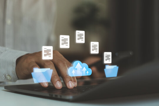 Transfer data document file folder to cloud using ai technology with online system for backup storage on mobile phone and laptop. Businessman hand touch on document for send of document on internet.