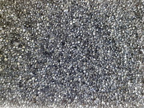 Black plastic bubble background. Massage part of a body wash sponge. Dark gray air-bubble part.