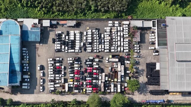 Many new cars are parked neatly in rows at a large outdoor facility in Banjarbaru, Indonesia