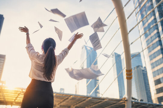 AI generated businesswoman throwing documents into the air modern city representing career freedom success achievement relief celebration workplace transformation