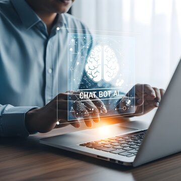 Person working on a laptop with a holographic chatbot interface displaying a brain icon.