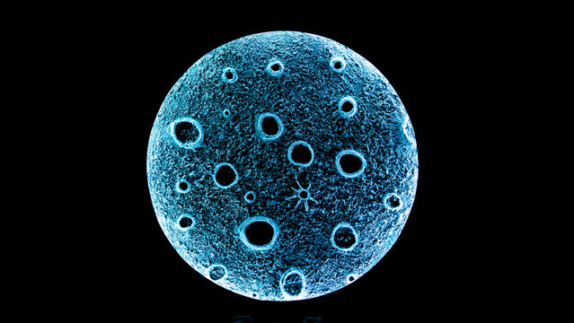 View of a glowing blue moon-like sphere with textured craters displayed at the Oregon Country Fair in Veneta, Oregon, United States.