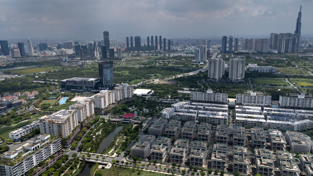 Aerial view of modern shophouses and apartments in Sala City, District 2, Ho Chi Minh City, Vietnam. Red pedestrian bridge in foreground.