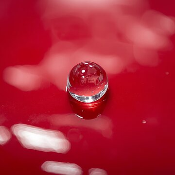 Clear Glass Sphere Reflecting on Vibrant Red Surface