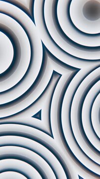 Animated abstract concentric rings with evolving shading and beveled relief across tiled geometric surface