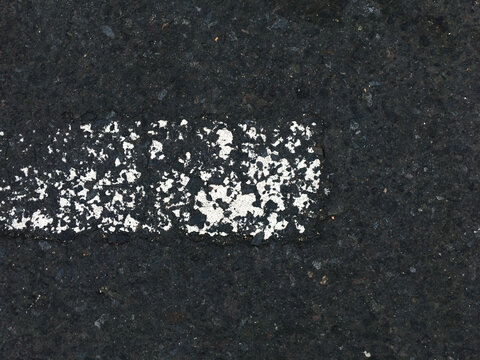 Asphalt road with old nearly missing color of white line, road background texture, asphalt texture