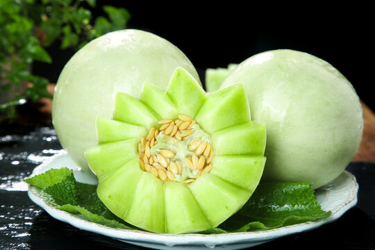 Fresh Green Melons from Shandong China with Decorative Cut Display on White Plate