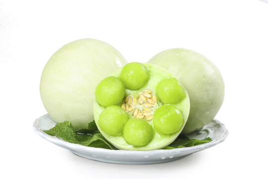Fresh Green Melon Balls and Sliced Fruit from Shandong Nanhui Region on White Plate
