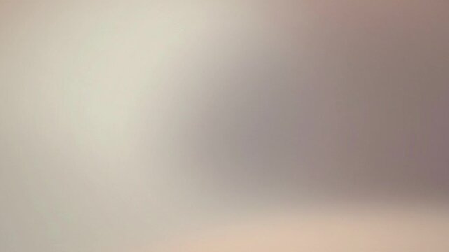 Warm light expands gently into a soft mauve and taupe color wash