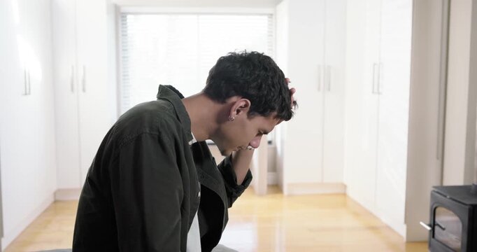 African American man sitting upright at bed edge, rubbing forehead, covering face, copy space