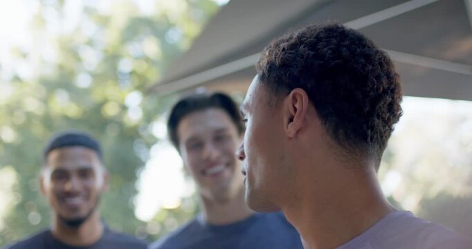 Diverse male friends, front man speaking, stepping in, posing under canopy in tshirts, copy space