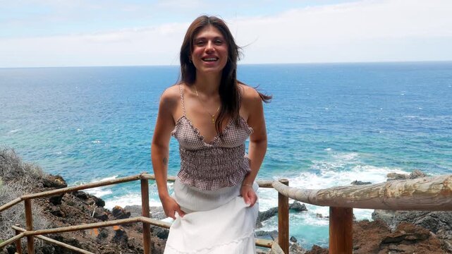 Beautiful woman walking up ocean view stairs
