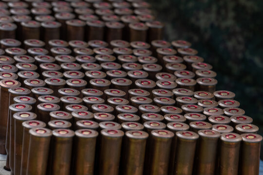 Rifle ammunition bullets row closeup texture background target shooting sport training view.
