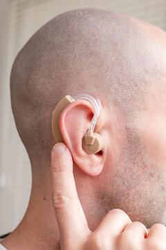 Young man with beige hearing aid in ear, close up portrait, BTE hearing support, accessibility, modern technology, inclusion, health care, confidence and everyday life, Modern healthcare solutions