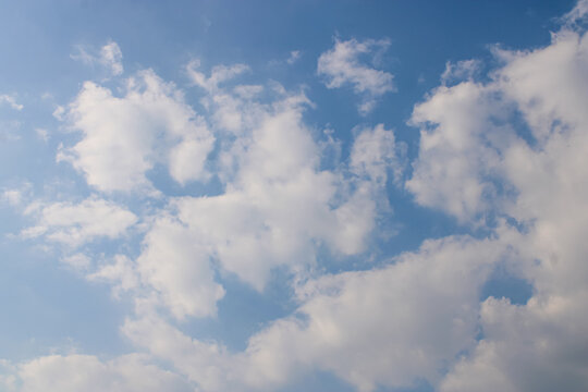 Fluffy White Clouds On Blue Sky Background