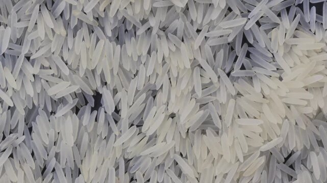 White basmati rice grains macro camera panning up handheld shot, FHD