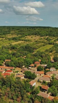 Aerial around view of old rustic vintage houses with wine cellars in Rogljevacke pivnice in Negotin region of Serbia. Vertical video 4k