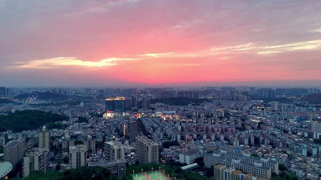 Stunning Aerial View of Dusk Over Guangzhou City in China Featuring Dramatic Colorful Twilight Sky Above Infinite Horizon of Highrise Buildings Residential Neighborhoods and Early Urban Lights