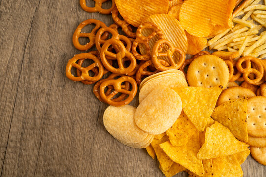 Mix of variety snack chips pretzel and cracker, junk crunchy food.