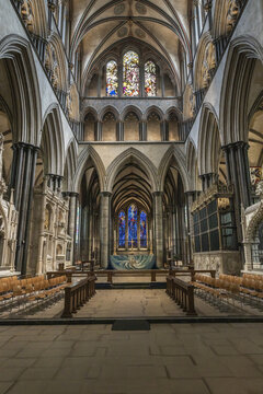 Salisbury, United Kingdom - 23 July 2026: View of the interior of Salisbury Cathedral, featuring Gothic architecture, vaulted ceilings, stained glass windows, and rows of wooden chairs.