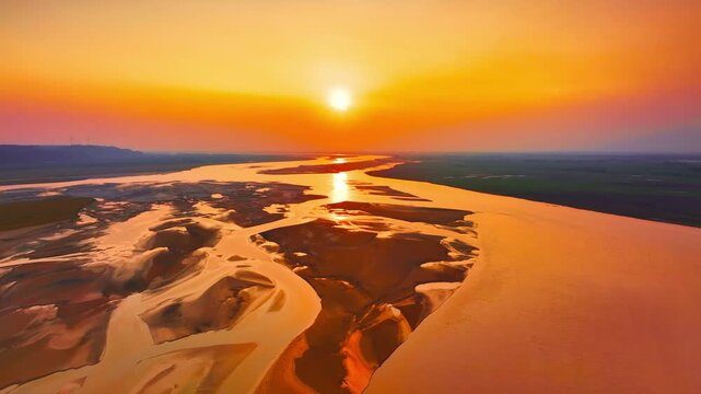 Aerial view of Yellow River at sunset, golden hour China landscape, wide drone shot of river delta and sandbars