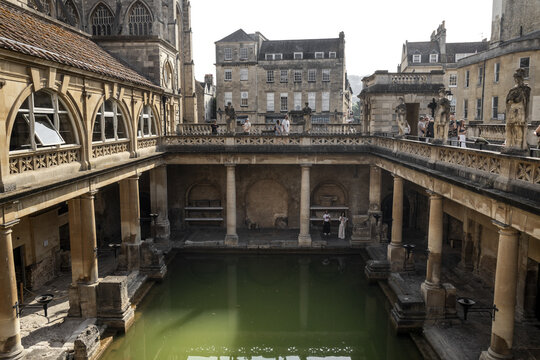 Bath, United Kingdom - 23 July 2026: View of the historic Roman Baths with its iconic green thermal pool, ancient stone columns, and surrounding classical architecture.