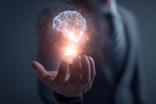 Glowing circuit brain concept held by businessman