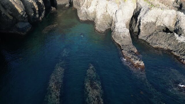 Nanatsugama Cliffs in Saga, Japan &mdash; Dramatic Aerial Drone View of Basalt Sea Cliffs and Caves on the Genkai Sea