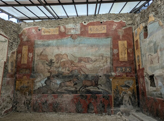 Ancient Roman mural preserved in the archaeological ruins of Pompeii, Italy, showcasing decorative painting and artistic details from the Roman period © Carlos E. Urrutia