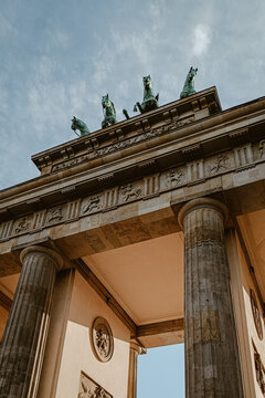 Berlin, Germany - 03 June 2026: View of the Brandenburg Gate with its iconic quadriga statue atop the neoclassical columns under a clear blue sky.