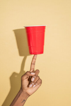 Balancing red cup on finger