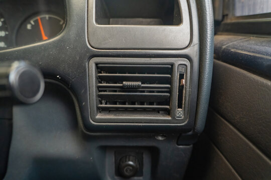 Close up of a car dashboard air conditioning ventilation vent during extreme global warming heatwaves, highlighting cooling systems and cabin comfort challenges.
