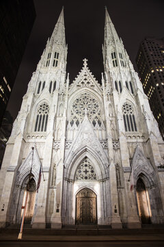 New York, United States - 03 October 2016: View of St. Patrick's Cathedral at night with illuminated neo-Gothic spires and intricate stone facade.